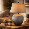 1502202669919ae3e6ad2.jpeg Buen 28 Inch Hydrocal Table Lamp, Drum Shade, Urn Base, Gray Rust Frost
