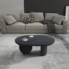 Uri 38 Inch Oval Coffee Table, Mango Wood Full and Half Spherical Leg, Sandblasted Black